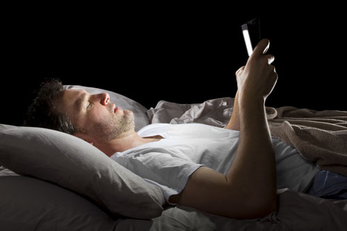 man_in_bed_spending_time_in_front-of-tablet